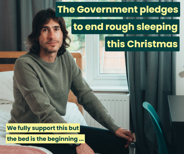 A man sitting on a bed in his own room. Text reads: The Government pledges to end rough sleeping this Christmas. We fully support this but the bed is the beginning.